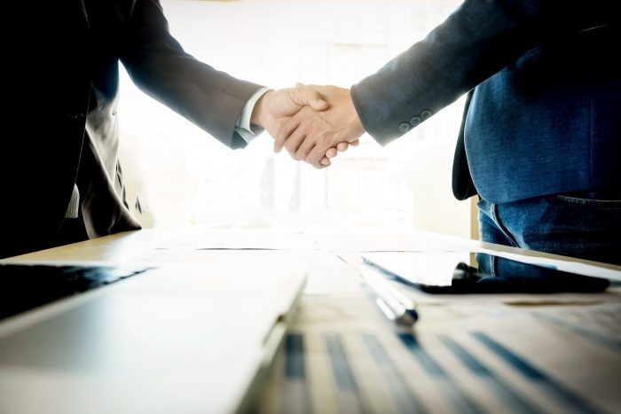 Businesspeople shaking hands - learn hebrew