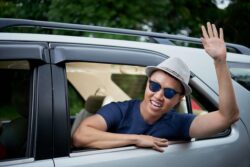 Japanese greeting a friend from his car