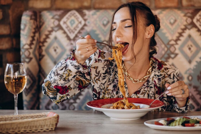 Woman eating past at an Italian restaurant