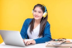 Female student with her headphones on studying Chinese words