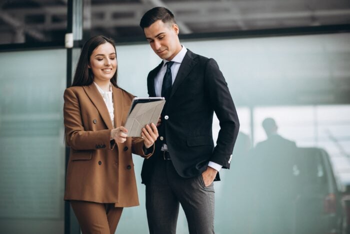 Young businesspeople conversing using Polish words