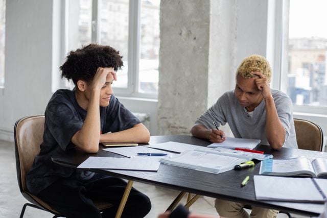 Students working together on a language exercise, illustrating the process of learning how Turkish verb forms are structured.